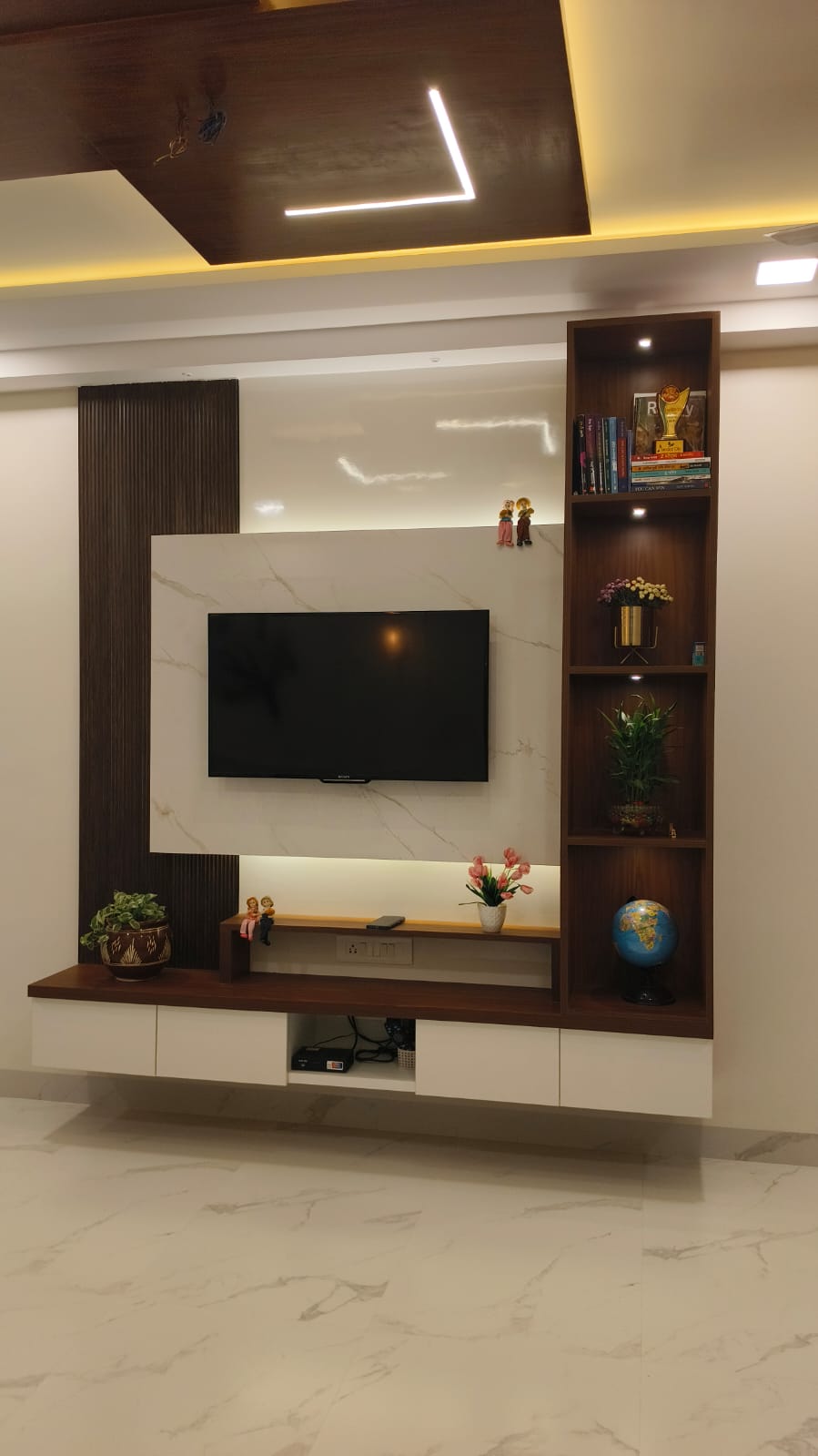 TV unit with marble panel and wooden false ceiling by Artmarque, Pune