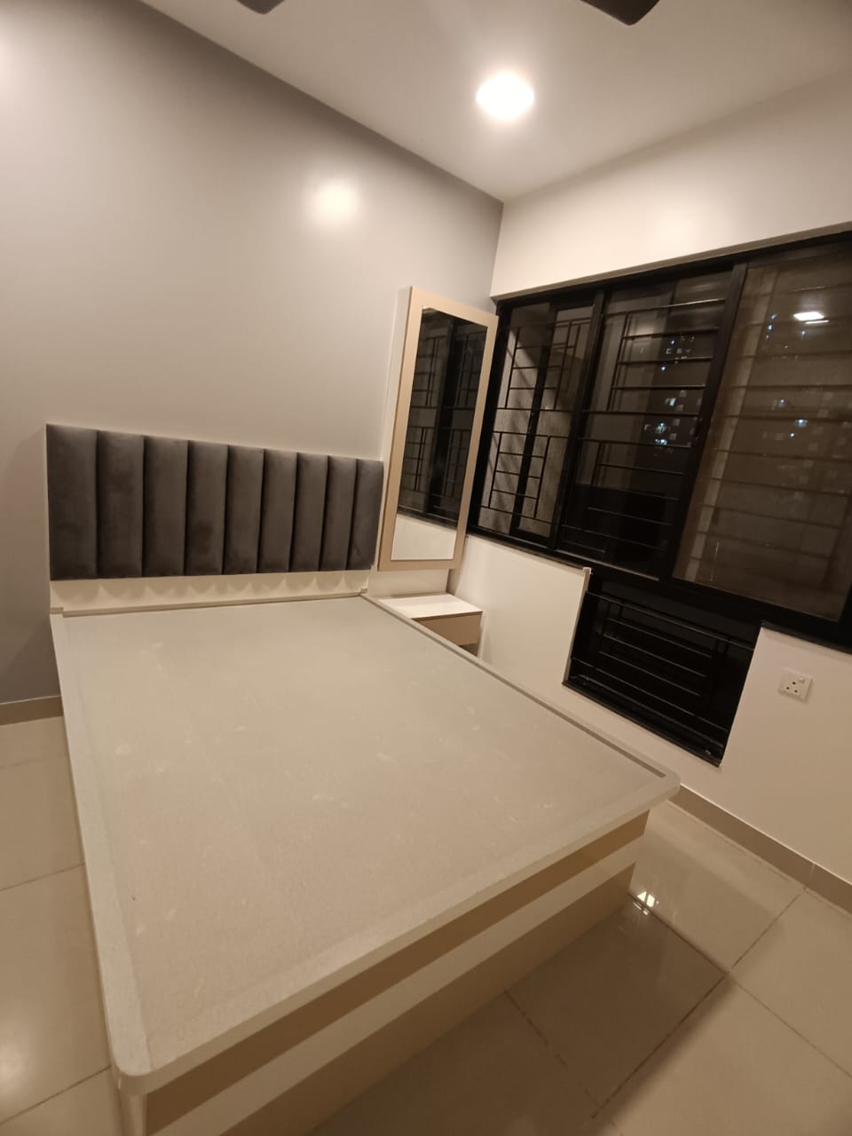 Master bedroom with upholstered headboard by Artmarque, Pune